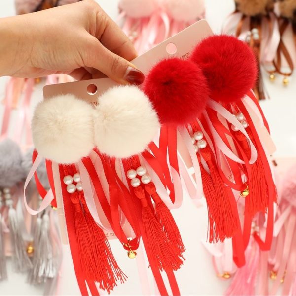Pince à cheveux enfant style chinois avec pompons et cloche rouge